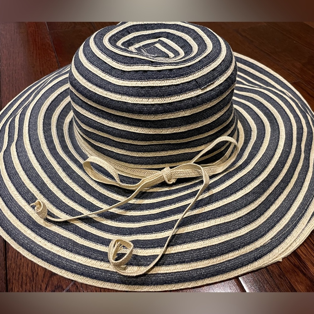 Wide rimmed blue and cream coloured sun hat with with ribbon.